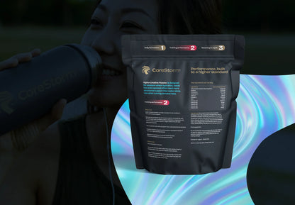 Person holding a CoreStorm supplement package with a colorful abstract background