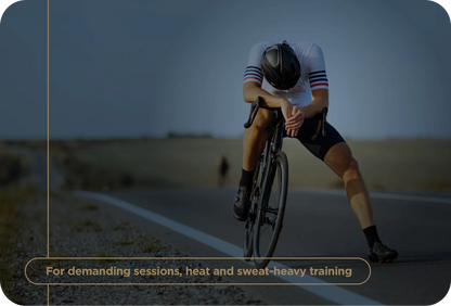 Cyclist in a racing outfit on a road with text about demanding training sessions.