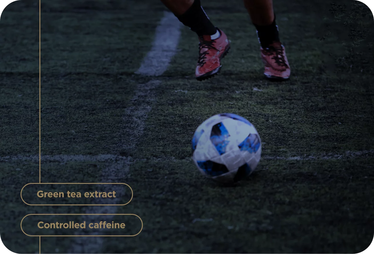 Person preparing to kick a soccer ball on a field with text about green tea extract and controlled caffeine.