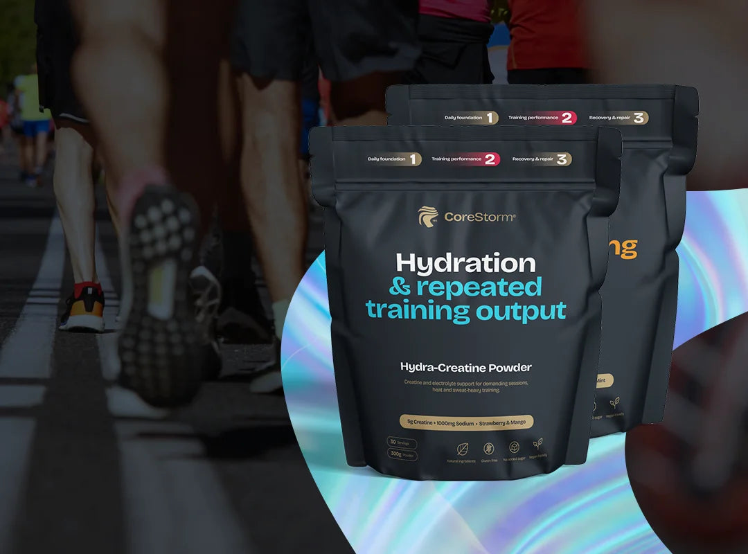 CoreStorm Hydration & Repeated Training Output powder packages with people walking in the background.
