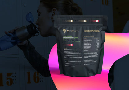 Person holding a CoreStorm supplement package with a colorful gradient background